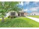 Attractive one-story home with neutral siding, stone accents, and a well-manicured lawn at 6755 Biscayne Blvd, Rex, GA 30273