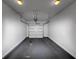 Clean, minimalist garage featuring a white door and ample storage space at 6755 Biscayne Blvd, Rex, GA 30273