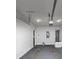 Spacious garage featuring lighting fixtures, storage, and an attached water heater at 6755 Biscayne Blvd, Rex, GA 30273