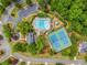 Stunning aerial view showcasing the community pool, tennis courts, playground and lush landscaping at 940 Kinghorn Nw Dr, Kennesaw, GA 30152