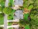 Aerial view of a well-maintained home with a manicured lawn, mature trees, and a playground at 940 Kinghorn Nw Dr, Kennesaw, GA 30152