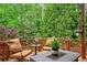 Cozy back deck features comfortable seating and garden views, ideal for relaxation and outdoor gatherings at 940 Kinghorn Nw Dr, Kennesaw, GA 30152