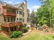Aerial view of a home's multiple wooden decks, backyard, playset, and lush landscaping at 940 Kinghorn Nw Dr, Kennesaw, GA 30152