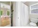 Bright bathroom featuring a shower with a white curtain and toilet creating a clean and functional space at 940 Kinghorn Nw Dr, Kennesaw, GA 30152