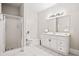 Elegant bathroom featuring a glass-enclosed shower, a white vanity, and modern fixtures at 940 Kinghorn Nw Dr, Kennesaw, GA 30152