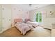 Bright bedroom featuring twin beds, rainbow wall art, and ample natural light creating a cheerful and playful space at 940 Kinghorn Nw Dr, Kennesaw, GA 30152