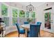 Cozy breakfast nook featuring bright blue chairs and light-filled windows with white shutters at 940 Kinghorn Nw Dr, Kennesaw, GA 30152