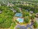 Aerial view of a community pool, tennis courts, mature trees, and parking area at 940 Kinghorn Nw Dr, Kennesaw, GA 30152