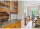 Elegant dining room with built-in cabinets, hardwood floors, and views of the landscaped outdoors at 940 Kinghorn Nw Dr, Kennesaw, GA 30152