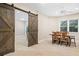 Spacious dining room with sliding barn doors, perfect for entertaining or Gathering meals at 940 Kinghorn Nw Dr, Kennesaw, GA 30152