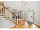 Welcoming foyer with a staircase, hardwood floors, and view into dining room through an arched doorway at 940 Kinghorn Nw Dr, Kennesaw, GA 30152