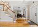 Inviting foyer with hardwood floors, staircase, and a view into dining room through an arched doorway at 940 Kinghorn Nw Dr, Kennesaw, GA 30152