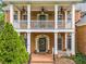 Close-up of a charming front porch with classic columns and a welcoming entrance at 940 Kinghorn Nw Dr, Kennesaw, GA 30152