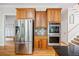 Updated kitchen features stainless steel appliances, wooden cabinetry, and a breakfast bar for casual dining at 940 Kinghorn Nw Dr, Kennesaw, GA 30152