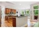 Spacious kitchen with stainless appliances, wood cabinets, an island, and breakfast bar seating at 940 Kinghorn Nw Dr, Kennesaw, GA 30152