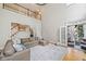 Expansive living room with hardwood floors, comfortable seating, a second-floor balcony, and access to an outdoor patio at 940 Kinghorn Nw Dr, Kennesaw, GA 30152