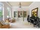 Inviting living room with built-in bookshelves, comfortable seating, piano and bright windows with shutters at 940 Kinghorn Nw Dr, Kennesaw, GA 30152