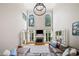 Soaring ceilings, a fireplace, and plentiful natural light make this living room an inviting and grand space at 940 Kinghorn Nw Dr, Kennesaw, GA 30152