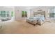 Spacious main bedroom features a sitting area, large windows, and tufted headboard at 940 Kinghorn Nw Dr, Kennesaw, GA 30152