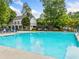 Inviting community pool featuring lounge chairs, umbrellas, and a spacious deck for relaxation at 940 Kinghorn Nw Dr, Kennesaw, GA 30152