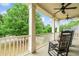 Relax on this comfortable porch with rocking chairs, columns, and wooded views at 940 Kinghorn Nw Dr, Kennesaw, GA 30152