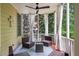Relax on this cozy screened porch, featuring comfortable seating, curtains and a ceiling fan for ultimate relaxation at 940 Kinghorn Nw Dr, Kennesaw, GA 30152