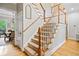 Staircase featuring carpeted steps, wood railings, and abundant natural light from nearby windows at 940 Kinghorn Nw Dr, Kennesaw, GA 30152