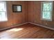 Bedroom featuring hardwood floors, wood-paneled walls, and a large window at 1235 Westboro Sw Dr, Atlanta, GA 30310
