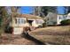 Charming single-Gathering home with a tidy front yard and an unfinished basement garage at 1235 Westboro Sw Dr, Atlanta, GA 30310