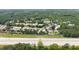 Aerial view of Holcomb's Crossing community, showcasing the townhomes and surrounding greenery, with highway in foreground at 238 Chads Ford Way, Roswell, GA 30076
