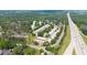 Aerial view of townhome community with highway access showing lush green landscape, and parking for each unit at 238 Chads Ford Way, Roswell, GA 30076