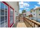 View of the balcony with painted red door and wooden railing, showcasing the outdoor living space of the house at 238 Chads Ford Way, Roswell, GA 30076