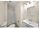The bathroom has a shower and a white vanity with a sink at 238 Chads Ford Way, Roswell, GA 30076
