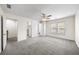 Well-lit bedroom boasts gray carpet, neutral walls, a ceiling fan, closet, and a window for natural light at 238 Chads Ford Way, Roswell, GA 30076