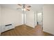 Bedroom featuring hard wood floors and a white ceiling fan at 238 Chads Ford Way, Roswell, GA 30076