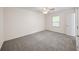 Bedroom features neutral walls, carpet flooring, natural light and a ceiling fan, providing ample space and comfort at 238 Chads Ford Way, Roswell, GA 30076