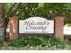 Community sign for Holcomb's Crossing, a private residential community, set among lush greenery and brick pillars at 238 Chads Ford Way, Roswell, GA 30076