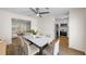 Open dining area features a modern light fixture, and seamlessly connects to the kitchen and living room at 238 Chads Ford Way, Roswell, GA 30076