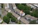 Aerial view of Holcomb's Crossing townhomes with neutral exterior, roof detail, green space, and parking at 238 Chads Ford Way, Roswell, GA 30076