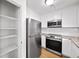 Efficient kitchen features modern stainless steel appliances, ample cabinet space, and a pantry for additional storage at 238 Chads Ford Way, Roswell, GA 30076