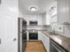 Well-lit kitchen with white cabinets, stainless steel appliances, granite countertops, and subway tile backsplash at 238 Chads Ford Way, Roswell, GA 30076