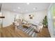 Bright living room with wood floors, modern furniture, and large windows for plenty of natural light at 238 Chads Ford Way, Roswell, GA 30076