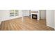 Open-concept living room features wood floors, a cozy fireplace, and a staircase at 238 Chads Ford Way, Roswell, GA 30076