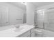 Bright bathroom featuring a white vanity, mirror, and a shower with glass doors at 2651 Briarlake Ne Rd, Atlanta, GA 30345