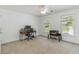 Bright bedroom featuring neutral carpet, white walls, a ceiling fan and two windows at 2651 Briarlake Ne Rd, Atlanta, GA 30345