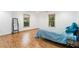 Basement bedroom featuring laminate flooring, two windows and a queen bed at 2651 Briarlake Ne Rd, Atlanta, GA 30345