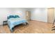 Finished basement bedroom with wood flooring and a bed with blue pillows and comforter at 2651 Briarlake Ne Rd, Atlanta, GA 30345