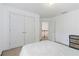This bedroom features white walls and floors with a view to the staircase from the entry doorway at 2651 Briarlake Ne Rd, Atlanta, GA 30345