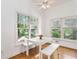 Sunny breakfast nook with white table and benches, large windows, and hardwood floors at 2651 Briarlake Ne Rd, Atlanta, GA 30345