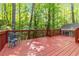 Enjoy a quiet seating area on the outdoor wooden deck, surrounded by lush greenery at 2651 Briarlake Ne Rd, Atlanta, GA 30345